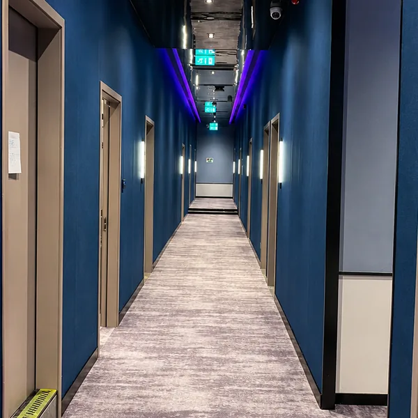 Room corridor with clear routing and blue lighting throughout photo