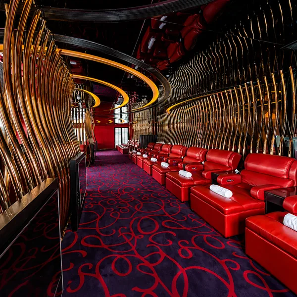 Red runway hall with curved walls and seating photo