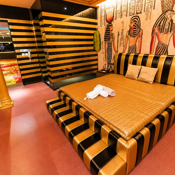 Egyptian theme room with gold motifs and warm light photo