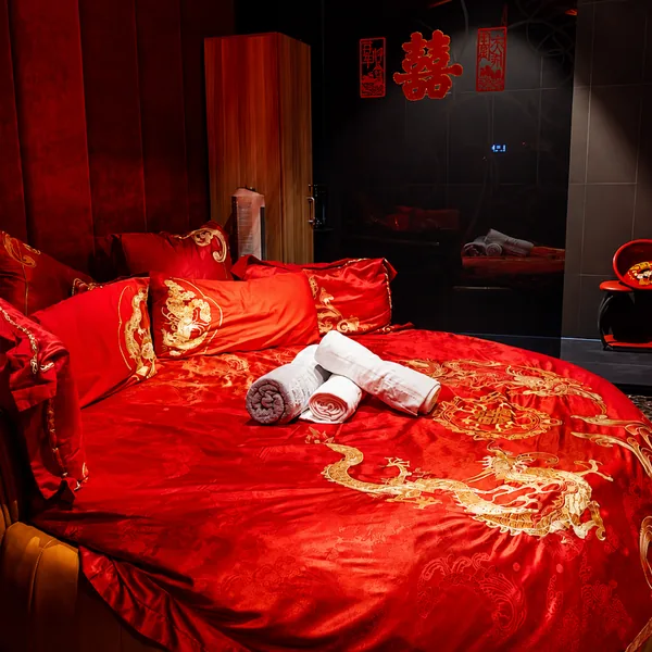 Chinese wedding theme suite with red bedding and festive details for stronger roleplay atmospher photo