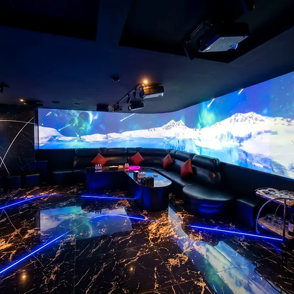 Panoramic KTV suite with large screens and wraparound seating for a private lounge feel photo
