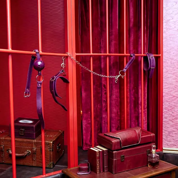 Red prop theme room with cage and chain details for a stronger scene setting photo